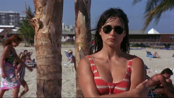 Movie still from “Striptease” (1996), directed by Andrew Bergman – A woman in a red and white striped swimsuit; Close Up shot, Low angle