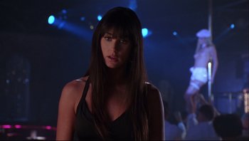 Movie still from “Striptease” (1996), directed by Andrew Bergman – A beautiful young woman with long hair standing in a room; Close Up shot, Over the shoulder angle