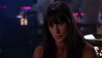 Movie still from “Striptease” (1996), directed by Andrew Bergman – A person with long black hair; Close Up shot, Over the shoulder angle