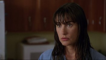 Movie still from “Striptease” (1996), directed by Andrew Bergman – A person with long black hair; Close Up shot, Over the shoulder angle