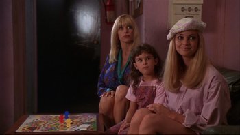 Movie still from “Striptease” (1996), directed by Andrew Bergman – A group of women sitting next to each other in a living room; Medium shot, High angle