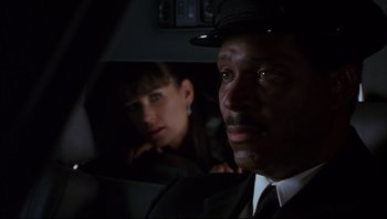 Movie still from “Striptease” (1996), directed by Andrew Bergman – A man and a woman sitting in the back of a car; Close Up shot, Low angle