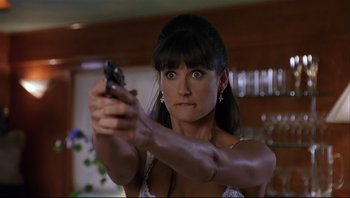 Movie still from “Striptease” (1996), directed by Andrew Bergman – A beautiful woman holding a gun while wearing a white dress; Close Up shot, Low angle