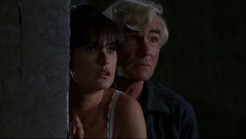 Movie still from “Striptease” (1996), directed by Andrew Bergman – A man and a woman standing next to each other; Close Up shot, Low angle