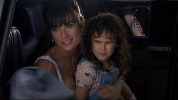 Movie still from “Striptease” (1996), directed by Andrew Bergman – A woman and a girl are posing for a picture; Close Up shot, High angle