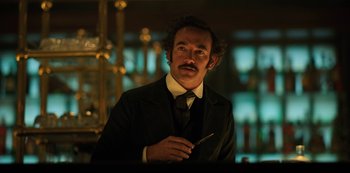 Movie still from “Altered Carbon” (2018), created by Laeta Kalogridis – A man in a suit and tie holding a knife; Close Up shot, Low angle