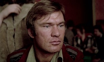 Movie still from “Stroszek” (1977), directed by Werner Herzog – A person wearing a jacket; Close Up shot, Low angle