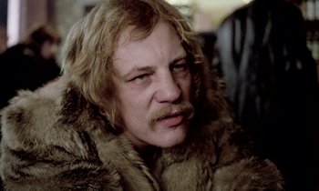 Movie still from “Stroszek” (1977), directed by Werner Herzog – A person wearing a fur coat; Close Up shot, Low angle
