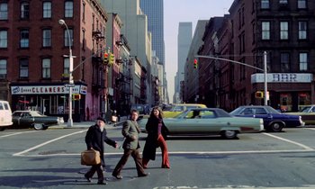 Movie still from “Stroszek” (1977), directed by Werner Herzog – A group of people crossing a street in a big city; Wide shot, Low angle