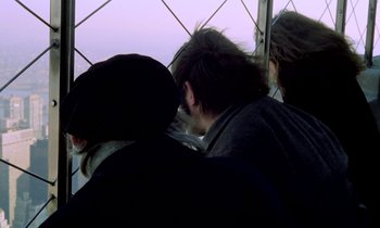 Movie still from “Stroszek” (1977), directed by Werner Herzog – A group of people sitting on top of a metal structure; Close Up shot, Over the shoulder angle