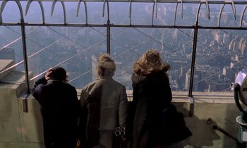 Movie still from “Stroszek” (1977), directed by Werner Herzog – Three women look out over the city from the top of the empire state building in new york city; Wide shot, High angle