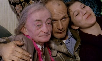 Movie still from “Stroszek” (1977), directed by Werner Herzog – A group of people posing for a picture together; Close Up shot, High angle