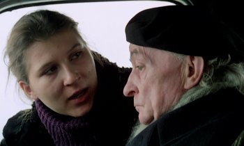 Movie still from “Stroszek” (1977), directed by Werner Herzog – An older man and a young woman in a car; Close Up shot, Over the shoulder angle