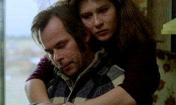 Movie still from “Stroszek” (1977), directed by Werner Herzog – A man and a woman are sitting close together; Close Up shot, High angle