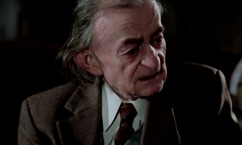 Movie still from “Stroszek” (1977), directed by Werner Herzog – An older man wearing a suit and a tie; Close Up shot, High angle