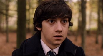 Movie still from “Submarine” (2010), directed by Richard Ayoade – A person wearing a suit and tie; Close Up shot, High angle
