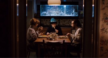 Movie still from “Submarine” (2010), directed by Richard Ayoade – A group of people sitting at a dinner table; Wide shot, High angle