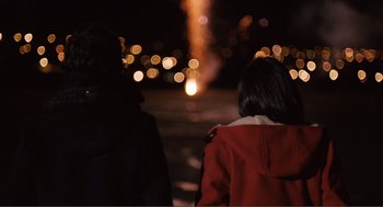 Movie still from “Submarine” (2010), directed by Richard Ayoade – Two people are looking out at the city lights at night; Medium shot, Over the shoulder angle