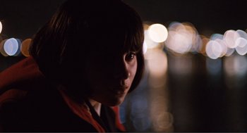 Movie still from “Submarine” (2010), directed by Richard Ayoade – A young woman is looking into the camera; Close Up shot, Low angle