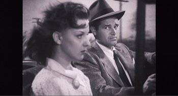 Movie still from “Submarine” (2010), directed by Richard Ayoade – A man and a woman sitting next to each other; Medium shot, Low angle