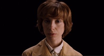 Movie still from “Submarine” (2010), directed by Richard Ayoade – A woman in a brown jacket is looking at the camera; Close Up shot, Low angle