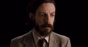 Movie still from “Submarine” (2010), directed by Richard Ayoade – A person wearing a suit and tie; Close Up shot, Low angle