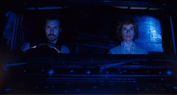 Movie still from “Submarine” (2010), directed by Richard Ayoade – A man and a woman sitting in the back of a car at night; Medium shot, Low angle