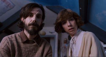 Movie still from “Submarine” (2010), directed by Richard Ayoade – A man and a woman standing next to each other in a room; Close Up shot, Low angle