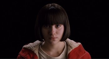 Movie still from “Submarine” (2010), directed by Richard Ayoade – A young woman with short black hair wearing a red jacket; Close Up shot, Low angle