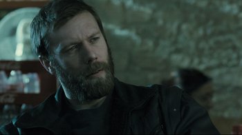 Movie still from “Submarino” (2010), directed by Thomas Vinterberg – A man with a beard and a black jacket; Close Up shot, Over the shoulder angle