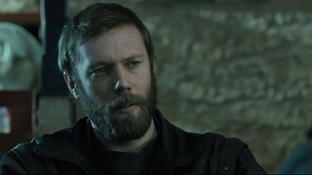 Movie still from “Submarino” (2010), directed by Thomas Vinterberg – A man with a long beard is looking at the camera; Close Up shot, Over the shoulder angle
