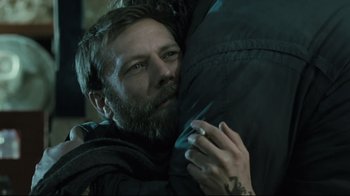 Movie still from “Submarino” (2010), directed by Thomas Vinterberg – A man with a beard is hugging another man; Close Up shot, Over the shoulder angle