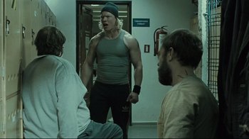 Movie still from “Submarino” (2010), directed by Thomas Vinterberg – A group of men standing in a room; Medium shot, Over the shoulder angle