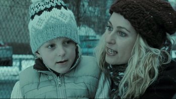 Movie still from “Submarino” (2010), directed by Thomas Vinterberg – A woman and a child wearing winter hats; Close Up shot, Over the shoulder angle