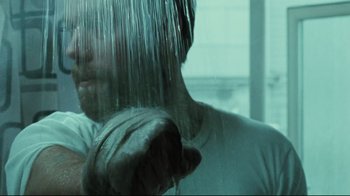 Movie still from “Submarino” (2010), directed by Thomas Vinterberg – A man in the shower is taking a shower; Close Up shot, Low angle
