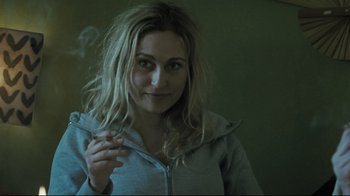 Movie still from “Submarino” (2010), directed by Thomas Vinterberg – A woman is smoking a cigarette in a room; Close Up shot, Over the shoulder angle