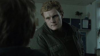 Movie still from “Submarino” (2010), directed by Thomas Vinterberg – A man in a green jacket looking at another man in a black jacket; Close Up shot, Over the shoulder angle