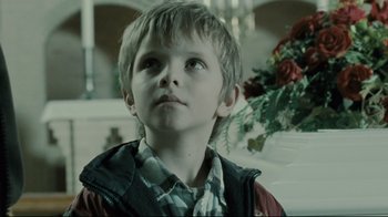 Movie still from “Submarino” (2010), directed by Thomas Vinterberg – A young boy is looking up at the sky; Close Up shot, Low angle