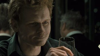Movie still from “Submarino” (2010), directed by Thomas Vinterberg – A person holding a glass of wine; Close Up shot, Over the shoulder angle