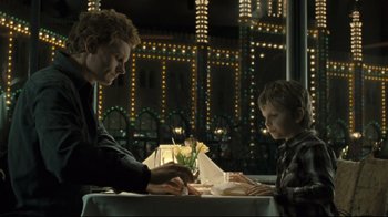 Movie still from “Submarino” (2010), directed by Thomas Vinterberg – A man and a boy sitting at a dinner table; Medium shot, Over the shoulder angle