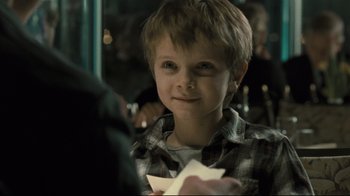 Movie still from “Submarino” (2010), directed by Thomas Vinterberg – A young boy holding a paper plane in a room; Close Up shot, Over the shoulder angle