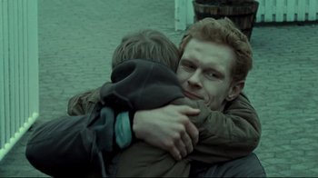 Movie still from “Submarino” (2010), directed by Thomas Vinterberg – Two people hugging each other on the street; Close Up shot, Over the shoulder angle