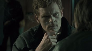 Movie still from “Submarino” (2010), directed by Thomas Vinterberg – A person smoking a cigarette; Close Up shot, Over the shoulder angle