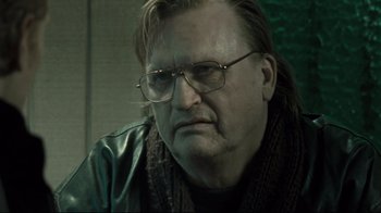 Movie still from “Submarino” (2010), directed by Thomas Vinterberg – An older man wearing glasses and a leather jacket; Close Up shot, Over the shoulder angle