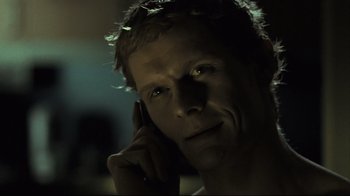 Movie still from “Submarino” (2010), directed by Thomas Vinterberg – A young man is talking on a cell phone; Close Up shot, Low angle