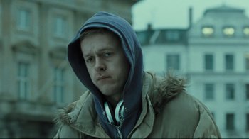 Movie still from “Submarino” (2010), directed by Thomas Vinterberg – A young man wearing a hooded jacket and headphones; Close Up shot, Low angle