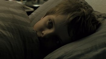 Movie still from “Submarino” (2010), directed by Thomas Vinterberg – A young boy laying in bed with his head on a pillow; Close Up shot, High angle