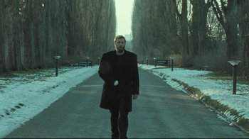 Movie still from “Submarino” (2010), directed by Thomas Vinterberg – A man walking down the street in the snow; Wide shot, Low angle