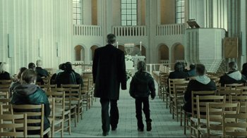 Movie still from “Submarino” (2010), directed by Thomas Vinterberg – A man and a child walking in a church; Wide shot, Low angle