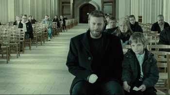 Movie still from “Submarino” (2010), directed by Thomas Vinterberg – A group of people sitting in a row of chairs; Medium shot, Over the shoulder angle